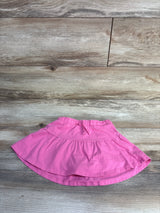 Top view of pink Jumping Beans girls skort 4T showing elastic drawstring waistband and layered skirt on wood background