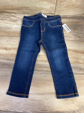 Dark wash kids jeans with yellow stitching and Old Navy tag on wood floor