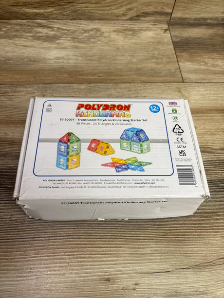 Front view of Polydron KinderMag Translucent Starter Set showcasing colorful translucent shapes and 48 pieces on a wood-grain floor