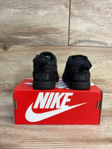Black Nike toddler sneakers on red shoebox, kids footwear for resale