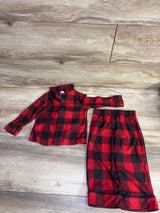 Red and black plaid children's pajama set with long-sleeve top and elastic waist pants on wood floor