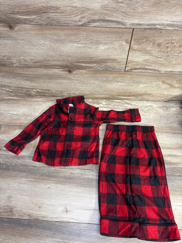 Red and black plaid children's pajama set with long-sleeve top and elastic waist pants on wood floor