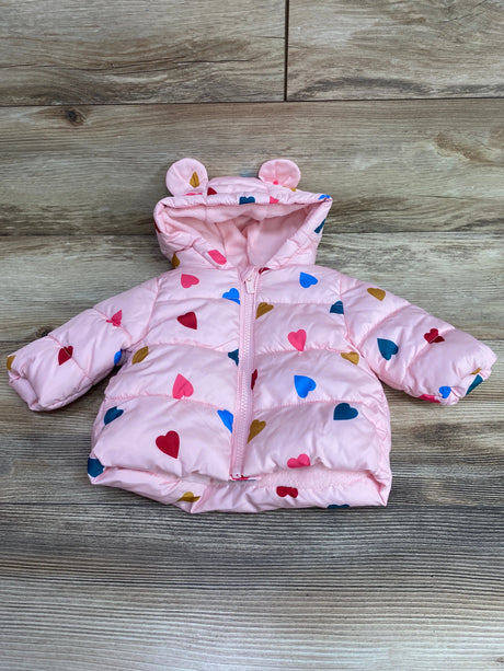 Front view of Old Navy pink puffer jacket with heart print and bear-ear hood on a wood background