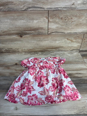 Pink floral baby dress on wood background, cotton short sleeve toddler outfit
