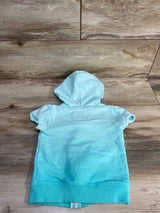 Back view of OshKosh B'gosh hooded toddler jacket size 2T showing short sleeves and ombre teal color on wood background