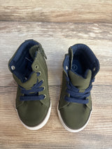 Pair of green toddler high-top sneakers with navy laces on wood floor