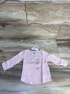Light pink long sleeve baby shirt size 6-12 months on wood floor
