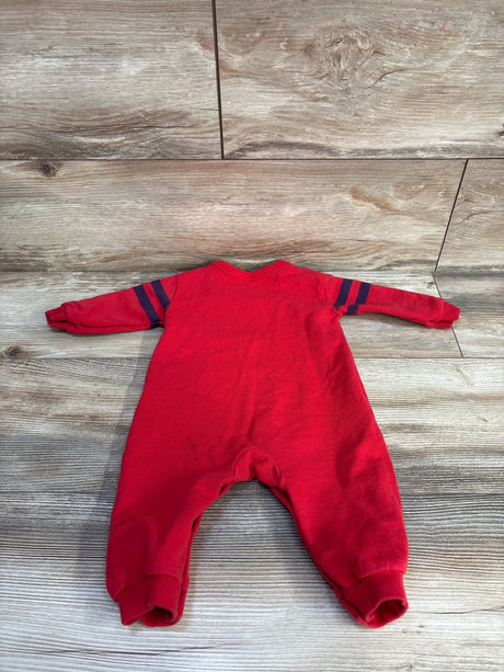Back flat lay of red Carter’s More Hugs baby coverall, long sleeves with navy stripes and ribbed cuffs on wood background
