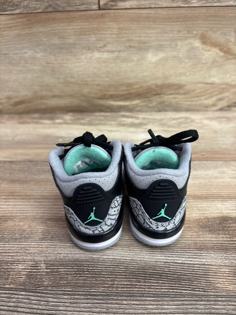 Rear view of Air Jordan 3 Retro TD Green Glow sneakers in size 4C showcasing black, white, gray elephant print, and green accents on a wood background
