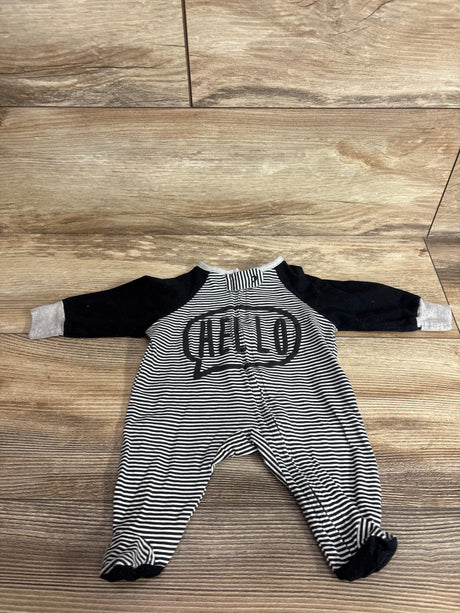 Flat lay of preemie Gerber footed sleeper showing black and white stripes, black sleeves, HELLO chest print on wood floor