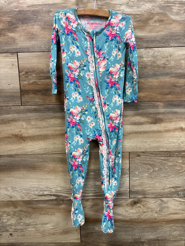 Front view of teal floral RuffleButts footie pajama with ruffled front zipper, long sleeves and built-in feet on wood wall