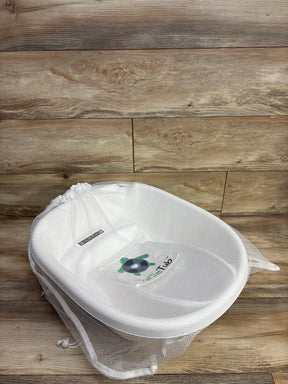 Angled top-down view of TurtleTub Swaddle Bath Tub showing white mesh fabric, contoured seat and TurtleTub logo on wood floor