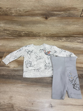 Top-down view of Disney Baby Dumbo sweatshirt and leggings set showcasing grey prints and ribbed leggings on a wood background
