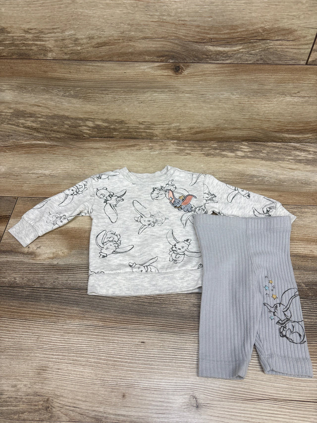 Top-down view of Disney Baby Dumbo sweatshirt and leggings set showcasing grey prints and ribbed leggings on a wood background