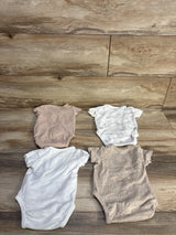 Flat lay of four H&M organic kimono-style baby bodysuits size 3m showcasing neutral beige, white, and print on wood floor