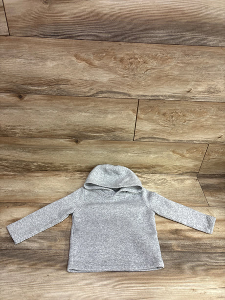 Front view of grey pullover hoodie in size 2/3T showcasing hood and long sleeves with wood plank background