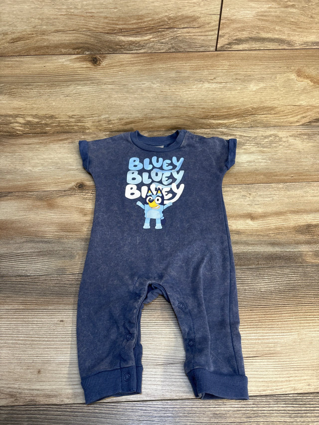 Blue toddler romper with Bluey character print, snap closures, on wood background