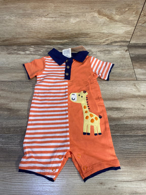 Front flat lay of orange baby polo romper with navy collar, striped left panel and giraffe patch, snap leg closures on wood
