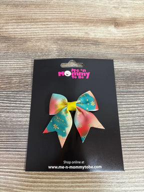 Colorful Christmas hair bow with snowflakes and 'Merry Christmas' text, perfect for kids' holiday outfits.