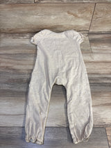 Back flat lay of beige Disney Baby Winnie the Pooh jumpsuit (18 months) showing puff sleeves and elasticized ankles on wood floor background