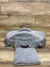 Front view of Momcozy CozyPro nursing pillow in grey showcasing a waist strap and front pocket on wood-look flooring