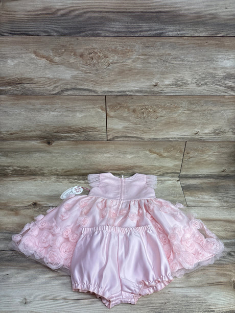 Nannette Baby 2pc pink rosette dress and matching bloomers set on a wooden background