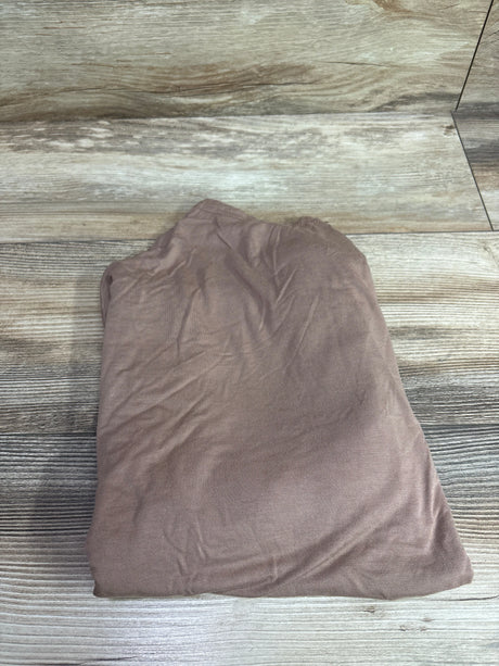 Top view of Seejoy bamboo multi-use car seat and nursing cover in brown, showing gathered fabric on wood flooring