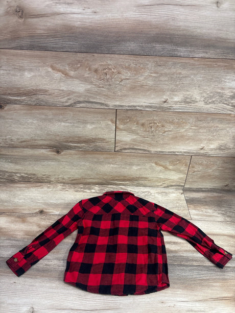 Red and black buffalo plaid button-up flannel shirt for toddlers on a wooden background.