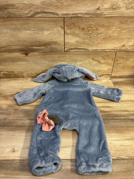 Back view of blue plush baby bunny costume size 9-12 months with hooded floppy ears, pink bow and fuzzy tail on wood background