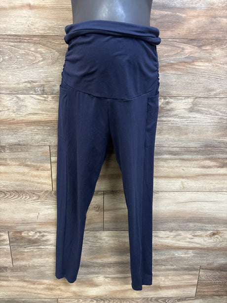 Front view of navy maternity ruched over-belly leggings showcasing the gathered panel and full-length legs on a wood floor