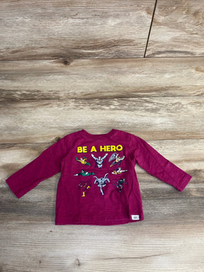 Flat-lay back view of Baby Gap infant long-sleeve T-shirt in cerise showing yellow BE A HERO and Justice League art on wood