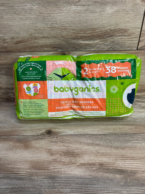 Front view of Babyganics Size 2 diaper pack showcasing Triple Dry Diapers label and 38 diapers text on wooden floor