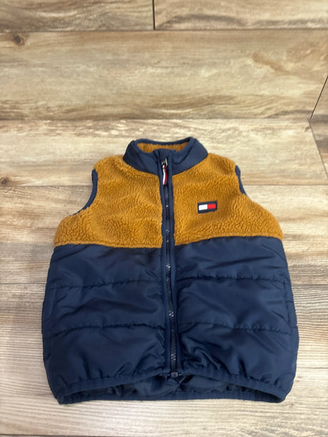 Front view of Tommy Hilfiger colorblock puffer sherpa vest, size 3T, with navy quilting and tan sherpa on wood floor