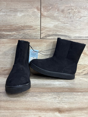 Black suede kids ankle boots with flat soles on wooden background, youth size 13