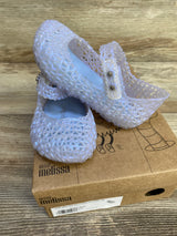 Angled view of Mini Melissa Campana Papel jelly flats in pearly blue showing lattice texture and Mary Jane strap on shoebox