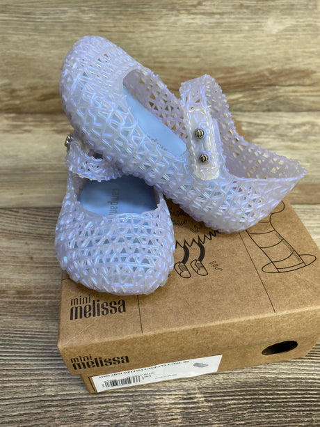 Angled view of Mini Melissa Campana Papel jelly flats in pearly blue showing lattice texture and Mary Jane strap on shoebox