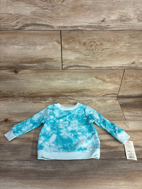 Baby long-sleeve tie-dye blue and white sweatshirt on wooden floor with size 6-9M tag