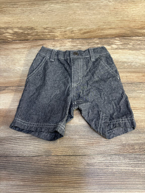Flat lay of grey Calvin Klein toddler shorts size 18 months showcasing white contrast stitching and button closure on wood tabletop