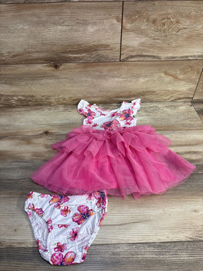 Flat lay of white toddler tutu dress with pink layered tulle skirt and matching floral bloomers, 18-24 months, on light wood background