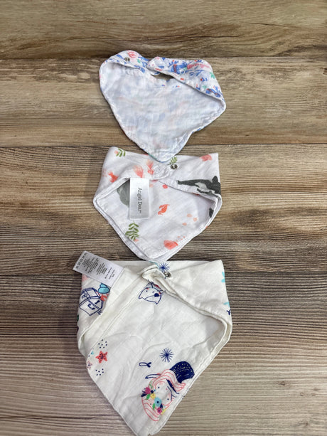 Three white Me n Mommy To Be patterned bandana bibs arranged on a wooden surface.