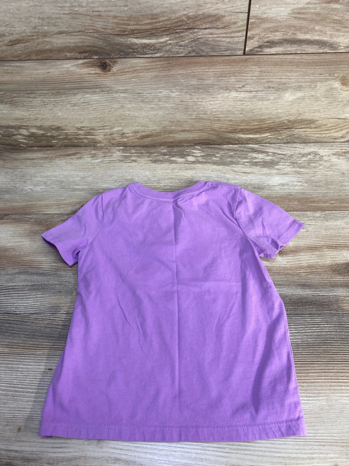 Flat lay back view of Cat & Jack lilac girls short-sleeve shirt size 5T showing plain back on wood floor