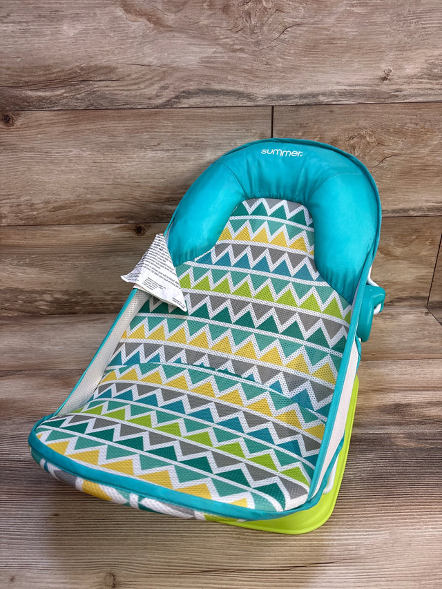 Colorful baby bouncer seat with geometric pattern on wood background