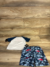Flat lay of Hurley rashguard set 24m showing white shirt with navy sleeves and blue camo shorts with red shark print