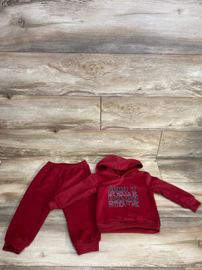 Children's red hoodie and sweatpants set on wooden floor with slogan hoodie saying life would be boring