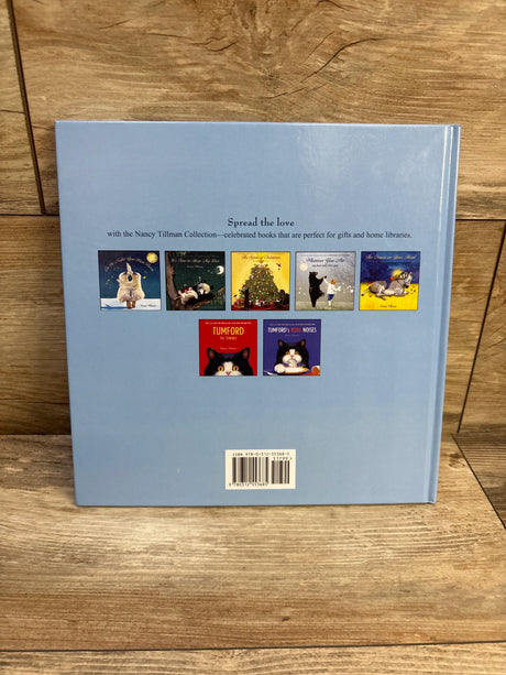 Back view of I’d Know You Anywhere, My Love hardcover showing light blue back with small thumbnails and barcode on wooden table