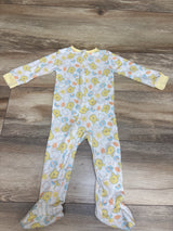 Front view of Disney Baby Winnie the Pooh sleeper showcasing footed legs and front zipper on a wood-grain surface