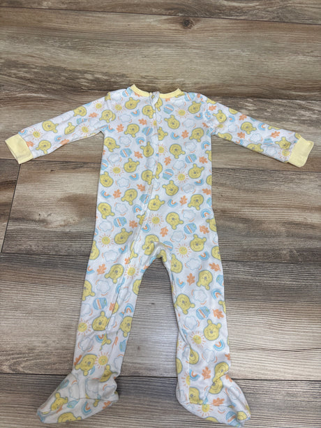 Front view of Disney Baby Winnie the Pooh sleeper showcasing footed legs and front zipper on a wood-grain surface