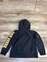 Black kids hoodie with yellow John Deere lettering on sleeve, displayed on wood floor
