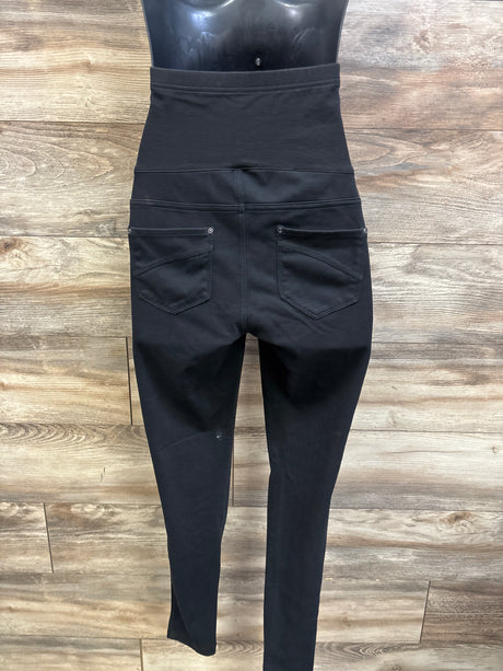 Back view of black Time & Tru maternity full panel jeggings with two back pockets on a wood floor