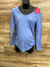 Front view of blue Isabel maternity long-sleeve shirt with V-neck and side ruching on mannequin against wood background